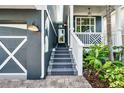 Inviting entryway with well-lit steps, leading to the front door and showcasing the home's exterior at 307B 63Rd St, Holmes Beach, FL 34217