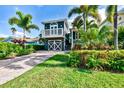Captivating home featuring a quaint balcony, delightful landscaping, and a charming curb appeal at 307B 63Rd St, Holmes Beach, FL 34217