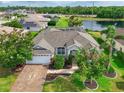 Stunning aerial view of a single-Gathering home boasting a manicured lawn, screened pool and scenic pond views at 3309 45Th E Ave, Bradenton, FL 34203