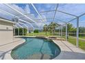 Sparkling screened-in pool with tranquil waterfall feature, integrated spa, and well-maintained patio at 3309 45Th E Ave, Bradenton, FL 34203