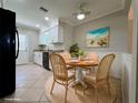Cozy dining area with a round table, four wicker chairs, and stylish decor, perfect for Gathering meals at 3600 Wisteria Pl, Punta Gorda, FL 33950
