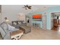 Comfortable living room featuring modern decor, tile flooring, a large TV, and a cozy seating arrangement at 3718 61St E Dr, Bradenton, FL 34203
