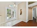 Welcoming foyer featuring tile flooring, a charming niche, and light-filled double front doors at 3919 Fan Palm Ct, Land O Lakes, FL 34638