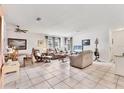 Bright and airy living room with neutral tones, tile flooring, and comfortable seating arrangements for relaxation and entertaining at 4023 Chestnut Ave, Sarasota, FL 34234