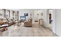 Spacious living room featuring tile floors, neutral walls, and a comfortable seating arrangement, offering a relaxing atmosphere at 4023 Chestnut Ave, Sarasota, FL 34234