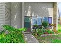 Close-up of the front entrance with colorful plants and a welcoming doorway at 4381 Sandner Dr, Sarasota, FL 34243