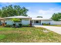 Inviting single-Gathering home boasts a well-maintained lawn, mature trees, a metal roof, and lovely landscaping at 4425 Parnell Dr, Sarasota, FL 34232