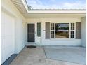 Inviting front entry featuring a screen door, storm windows, and a well-maintained exterior and clean trim at 4425 Parnell Dr, Sarasota, FL 34232