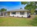 Well-kept single-Gathering home featuring manicured lawn, decorative shutters and a stone palm tree at 4506 20Th W St, Bradenton, FL 34207