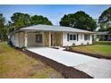 Well-kept home with an extra long driveway, stone accents, and a carport with newly installed concrete at 4506 20Th W St, Bradenton, FL 34207