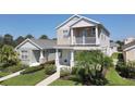Charming two-story home featuring a balcony, a well-manicured lawn, and inviting curb appeal with lush landscaping at 4811 Woodbrook Dr, Sarasota, FL 34243