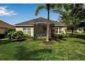 Home featuring a screened-in porch, well-maintained lawn, and lush greenery, offering a serene outdoor space at 5036 Brickell Park Cv, Bradenton, FL 34211