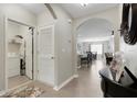 Hallway with laundry room to the left and views of the open kitchen and living area at 5111 11Th E St, Bradenton, FL 34203