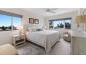 Bright bedroom features a queen bed, serene decor, and sun-filled windows at 5200 Gulf Dr # 408, Holmes Beach, FL 34217