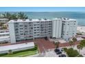 Exterior view of a beachfront condo building with a well-maintained facade and ample parking at 5200 Gulf Dr # 408, Holmes Beach, FL 34217