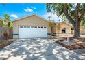 Charming one-story home featuring an attached garage, mature landscaping, and a welcoming front porch at 5623 Wilde Oak Way, Sarasota, FL 34232