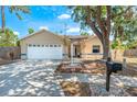 Charming one-story home featuring an attached garage, mature landscaping, and a welcoming front porch at 5623 Wilde Oak Way, Sarasota, FL 34232