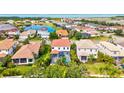 Wide aerial view of a neighborhood with various homes, ponds, and lush landscaping near a lake at 5823 Title Row Dr, Bradenton, FL 34210