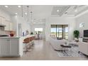 Bright, open-concept living space featuring a kitchen island with bar seating and comfortable lounging at 5987 Snowy Egret Dr, Sarasota, FL 34238