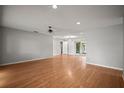 Spacious living room with hardwood floors, recessed lighting, and ceiling fan provides ample space for entertaining at 6512 Bowline Dr, Sarasota, FL 34231