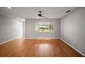 Bright living room features hardwood floors, a bay window, and neutral paint scheme that offers an open feel at 6512 Bowline Dr, Sarasota, FL 34231
