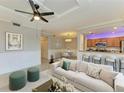 Bright living room featuring modern furniture, neutral decor, and open access to dining and kitchen areas at 6519 Grand Estuary Trl # 107, Bradenton, FL 34212