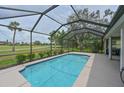 Relaxing screened-in pool with views of the well-manicured lawn and mature trees, offering a tranquil escape at 661 Foggy Morn Ln, Bradenton, FL 34212