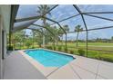 Screened-in pool overlooking a lush green landscape, providing a private and serene outdoor experience at 661 Foggy Morn Ln, Bradenton, FL 34212
