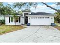Charming single-story home featuring a manicured lawn, a two-car garage, and classic curb appeal at 7 Arbor Oaks Dr, Sarasota, FL 34232