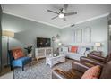 Comfortable living room with stylish furnishings, decor, and a ceiling fan at 7005 River Hammock Dr # 206, Bradenton, FL 34212