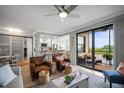 Inviting living room with access to a screened-in lanai with views of the water at 7005 River Hammock Dr # 206, Bradenton, FL 34212