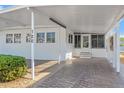 This cozy home boasts a covered carport that leads to the front entrance, accented by neat landscaping at 720 S Green Cir, Venice, FL 34285