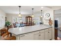 Eat-in kitchen boasts a large countertop, modern appliances, and a seamless flow to the dining and living areas at 720 S Green Cir, Venice, FL 34285