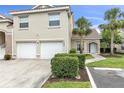 Inviting home exterior showcasing a well-manicured lawn, a two-car garage, and palm trees at 7637 Sweetbay Cir, Bradenton, FL 34203