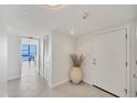 Bright entryway features tile flooring and a glimpse of the water view through the living area at 770 Palm Avenue # 903, Sarasota, FL 34236