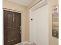 Hallway view showing the unit entrance door and elevator with fire safety instructions at 770 Palm Avenue # 903, Sarasota, FL 34236