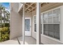 Exterior view of a condo unit with a covered porch and a door numbered 203 at 850 S Tamiami Trl # 203, Sarasota, FL 34236