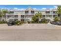 Attractive condominium complex with multiple units, stairways, and lush landscaping at 850 S Tamiami Trl # 203, Sarasota, FL 34236