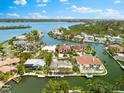 Overhead view features luxurious waterfront homes with private docks and boat lifts on a winding canal at 868 Siesta Key Cir, Sarasota, FL 34242