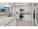 Modern kitchen featuring white cabinets, stainless steel appliances, and neutral countertops at 4517 Las Brisas Ln, Sarasota, FL 34238