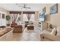 Cozy living room featuring tile flooring, plush sectional, and a ceiling fan at 11507 84Th Street E Cir # 102, Parrish, FL 34219