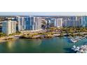 Aerial view of the waterfront community, featuring high-rise condos and a marina at 1155 N Gulfstream Ave # 406, Sarasota, FL 34236