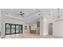 Spacious living room with recessed lighting, ceiling fan, hardwood floors, and sliding glass doors at 117 Marker Rd, Rotonda West, FL 33947