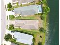 Aerial view of a property with a pool, situated on a waterfront lot, offering serene views and privacy at 12183 Longview Lake Cir, Bradenton, FL 34211