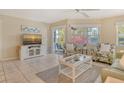 Bright and airy living room with tiled floors, ceiling fan, comfortable seating and a view of the screened porch at 1226 Siesta Bayside Dr # 1226C, Sarasota, FL 34242