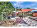 Charming home exterior featuring a brick walkway, cozy seating and beautiful shade canopies at 1489 18Th St, Sarasota, FL 34234