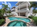 Inviting backyard features a kidney-shaped pool, spa, and patio area, perfect for outdoor relaxation and entertainment at 215 65Th St, Holmes Beach, FL 34217