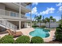 Relaxing backyard oasis with a sparkling pool, spa, and ample seating, ideal for enjoying sunny days at 215 65Th St, Holmes Beach, FL 34217