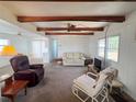 Inviting living room with exposed beams, neutral tones, and plenty of natural light at 237 Blackburn Blvd, North Port, FL 34287