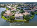 Expansive aerial view showcases the home's pool and serene lakefront setting at 2496 Farms Ct, Sarasota, FL 34240